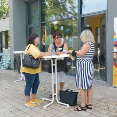 Drei Frauen unterhalten sich an einem Stehtisch beim Ehrenamtstreffen des Pakt für Pirmasens